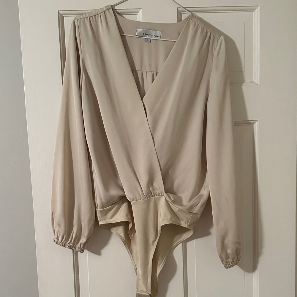 Adelyn Rae Cream Long Sleeve Bodysuit